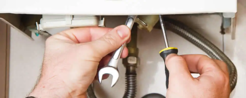 Boiler repair technician tightening pipe fittings and connections in Lakeland, FL