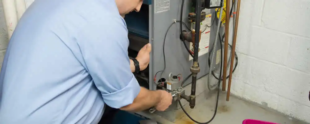 Furnace repair technician inspecting and servicing a home heating system in Lakeland, FL