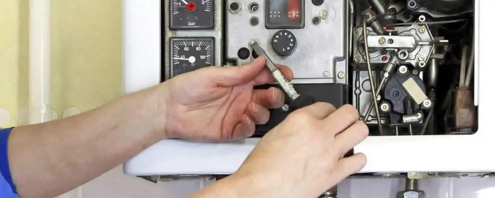 Heating repair technician adjusting boiler controls and components in Lakeland, FL