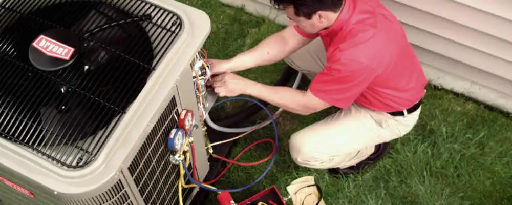 HVAC technician servicing an outdoor air conditioner unit in Lakeland, FL